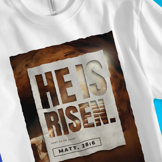 HE IS RISEN. (Easter Sunday) | Premium Unisex Christian T-Shirt, laid flat, designed by 3rd Day Christian Clothing UK