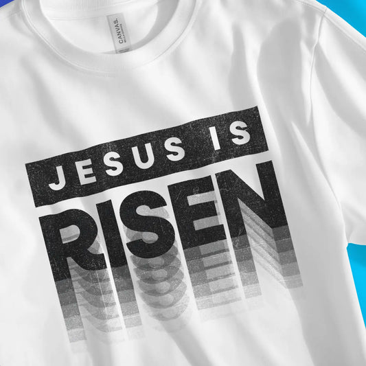 Jesus Is Risen (Typographic) | Premium Unisex Christian T-Shirt, laid flat, designed by 3rd Day Christian Clothing UK