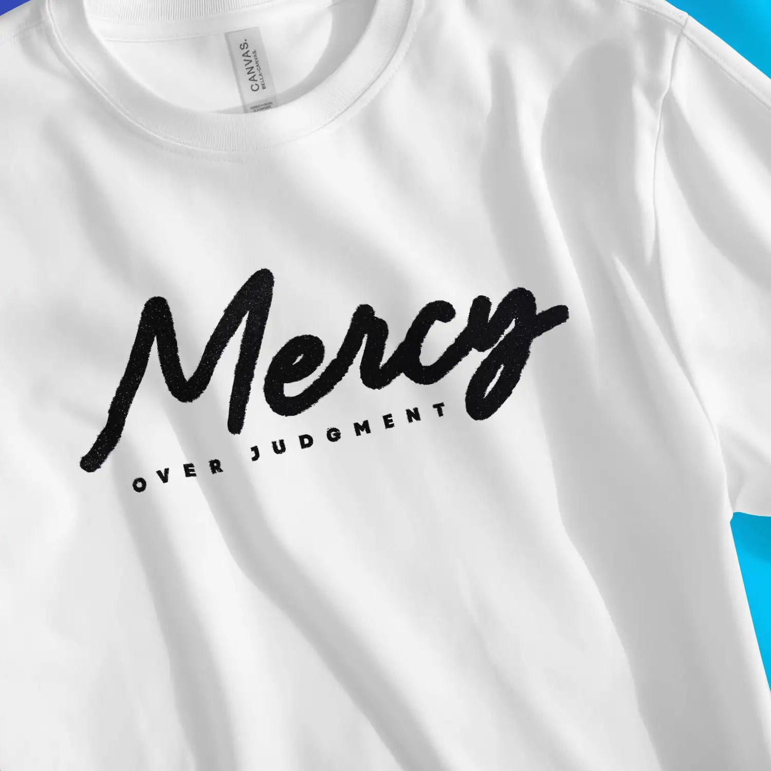 Mercy Over Judgment (Ink) | Premium Unisex Christian T-Shirt, laid flat, designed by 3rd Day Christian Clothing UK