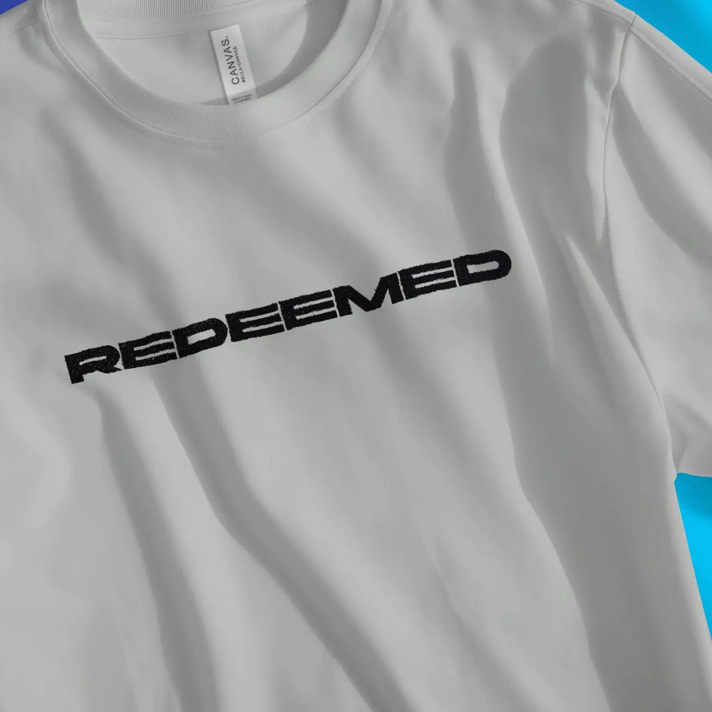 REDEEMED | Premium Unisex Christian T-Shirt, laid flat, designed by 3rd Day Christian Clothing UK