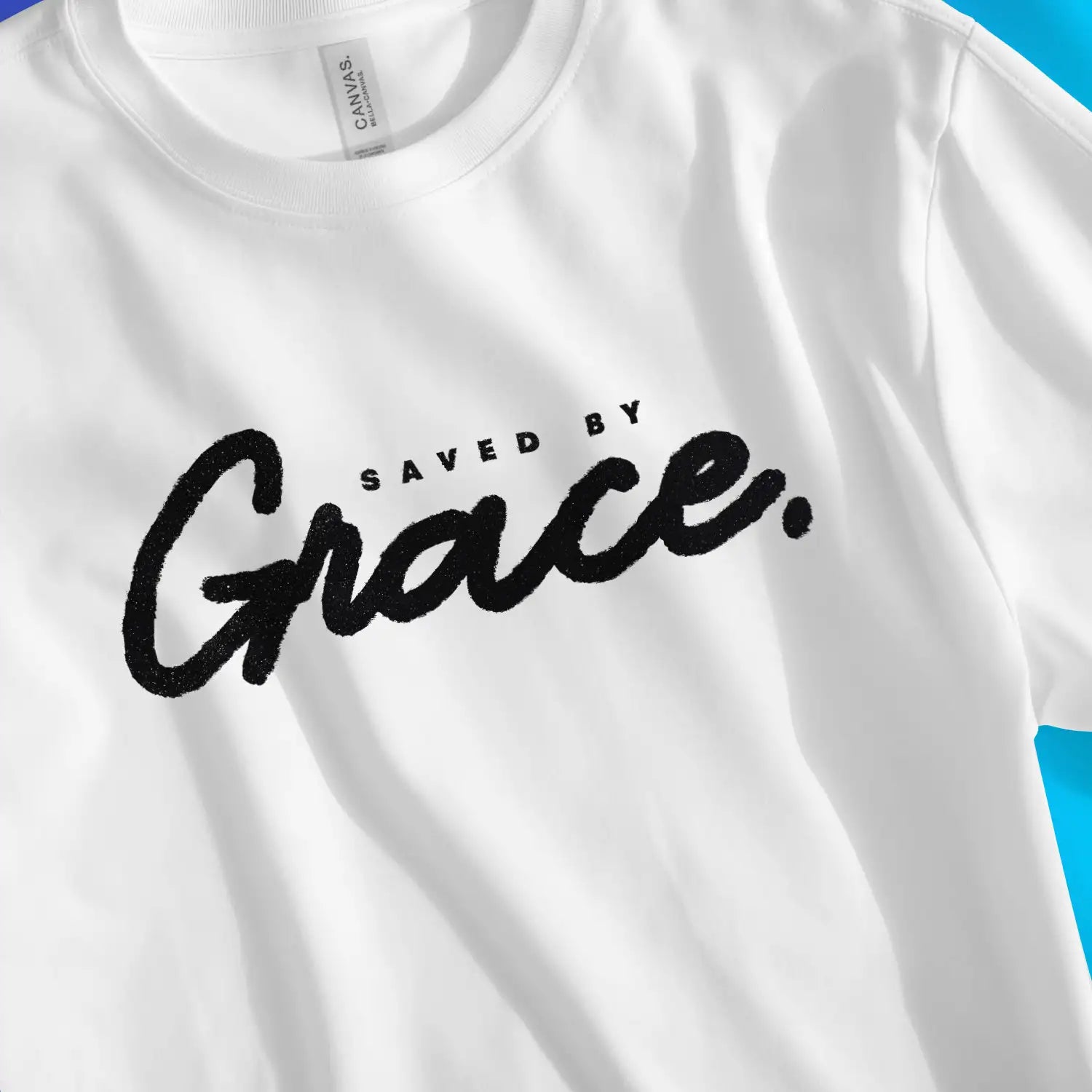 Saved By Grace (Ink) | Premium Unisex Christian T-Shirt, laid flat, designed by 3rd Day Christian Clothing UK