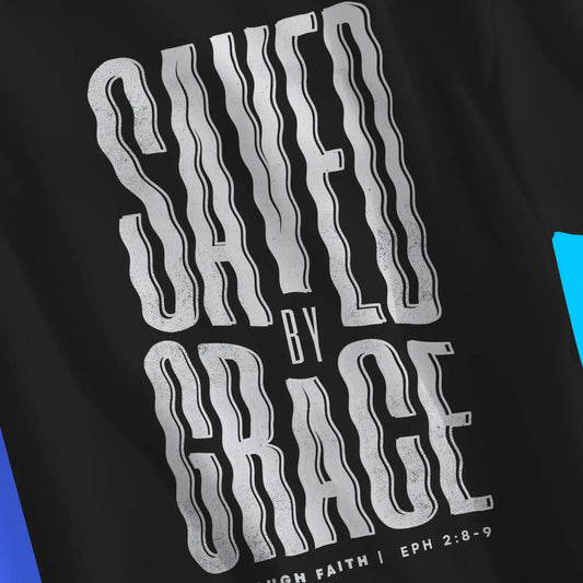 Saved By Grace (Wavy) | Premium Unisex Christian T-Shirt, laid flat, designed by 3rd Day Christian Clothing UK