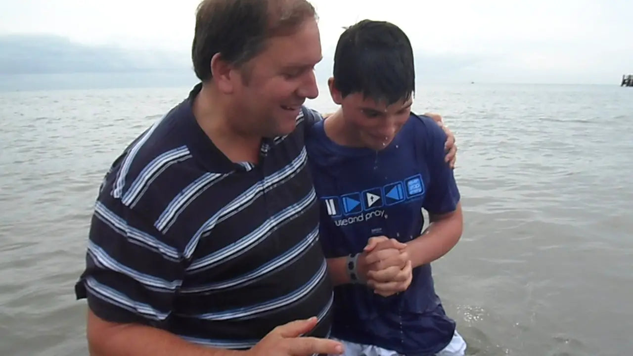 A young man on his baptism day wearing a Christian T-shirt